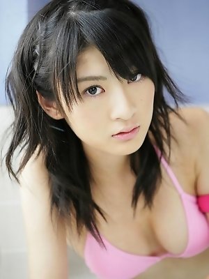 Adorable asian idol shows off her perky tits in a pink bikini
